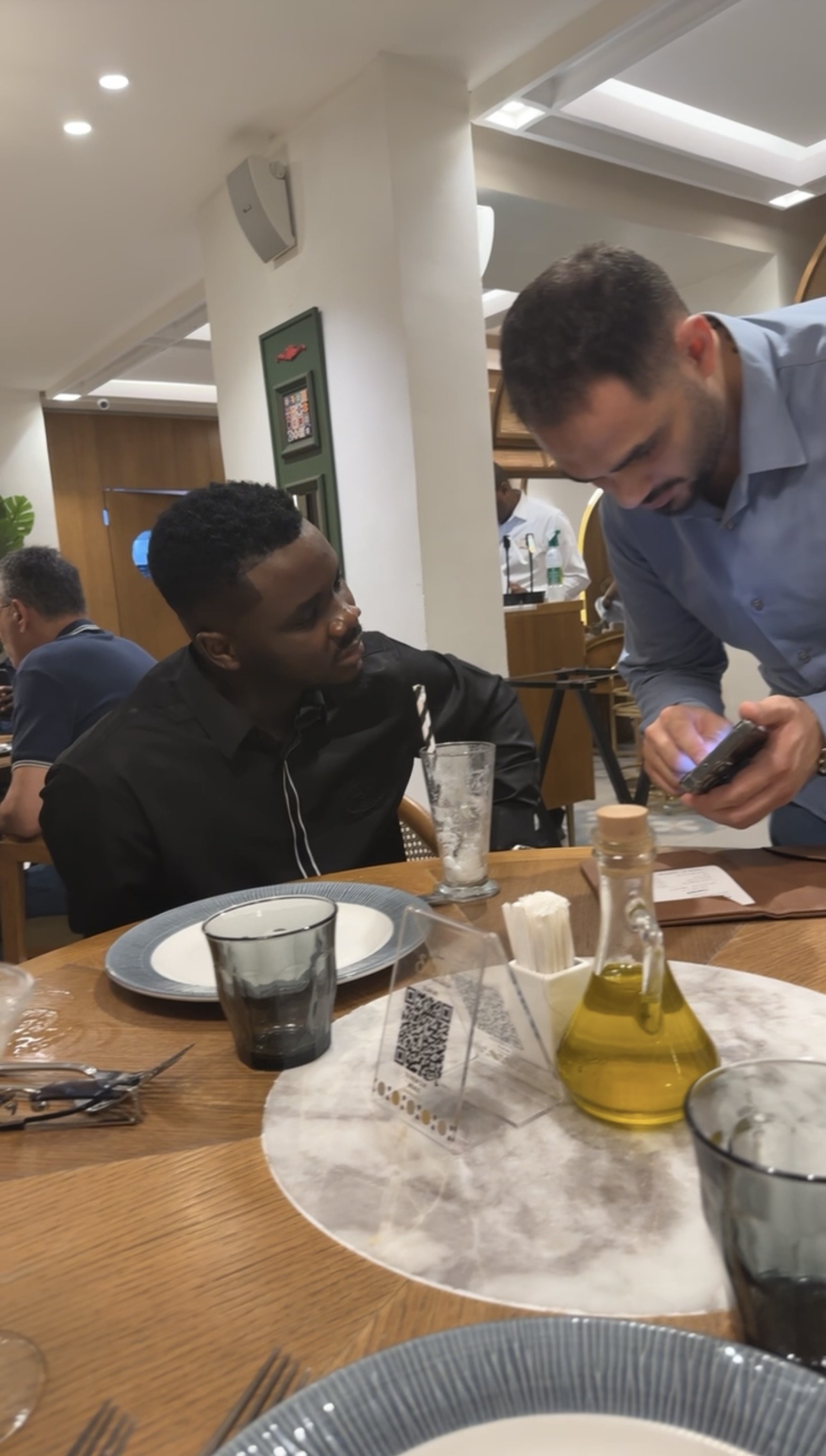 Daniel Larayetan meeting a client over dinner